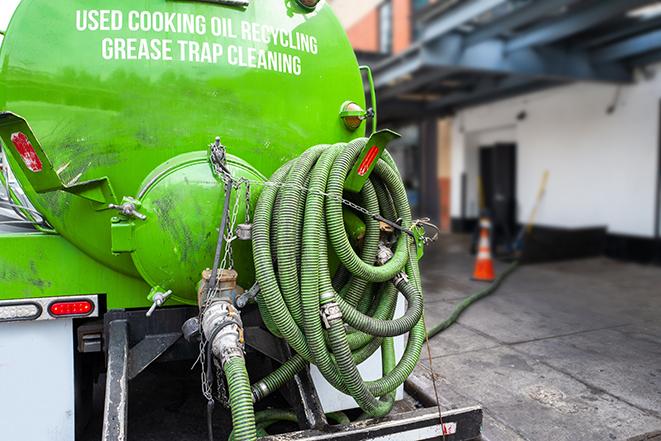 a grease trap being pumped by a sanitation technician in El Segundo, CA